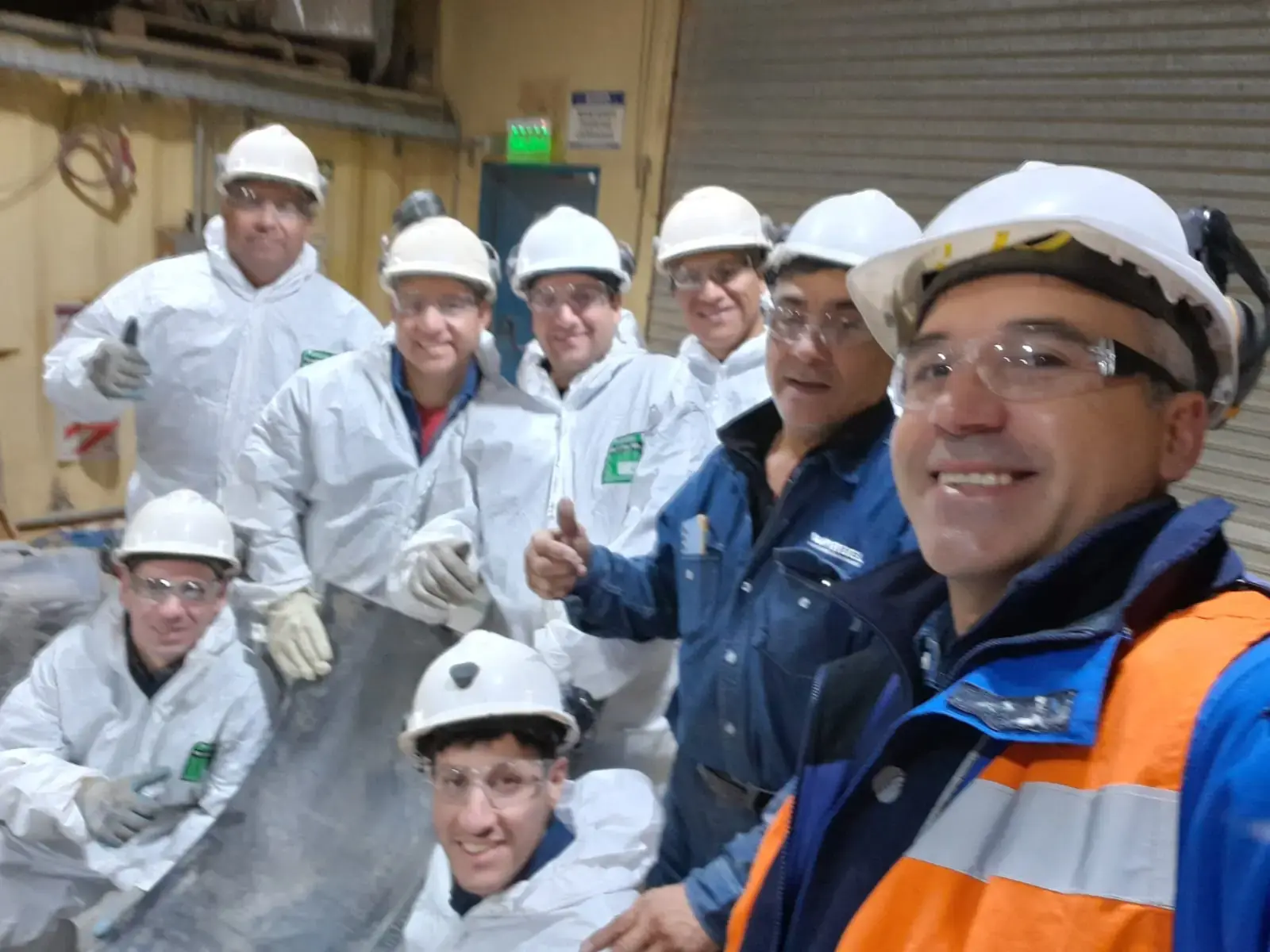 Equipo técnico Warbel con uniforme de seguridad sosteniendo banda transportadora en capacitación de Cerro Vanguardia